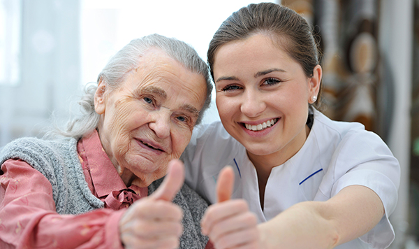 Nurse and resident giving thumbs up sign